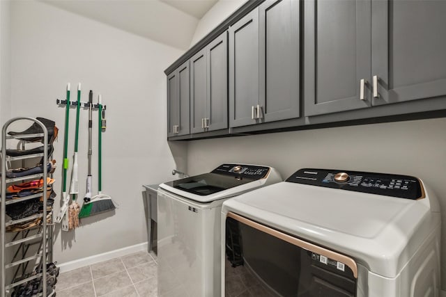 laundry area with cabinets, independent washer and dryer, and light tile patterned floors