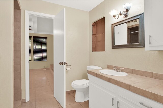 bathroom featuring tile patterned floors, vanity, and toilet