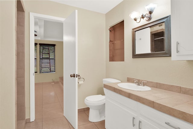 bathroom featuring vanity, tile patterned floors, and toilet