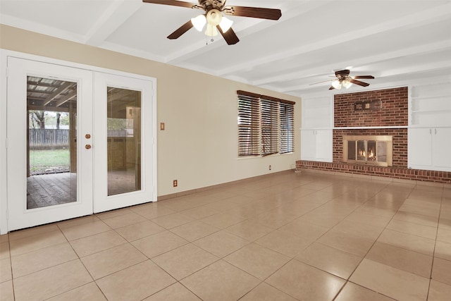 unfurnished living room featuring ceiling fan, light tile patterned flooring, beam ceiling, and french doors