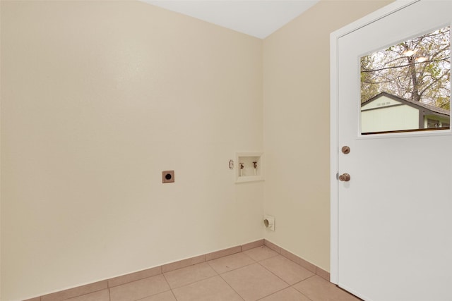 clothes washing area with hookup for a washing machine, light tile patterned floors, and electric dryer hookup