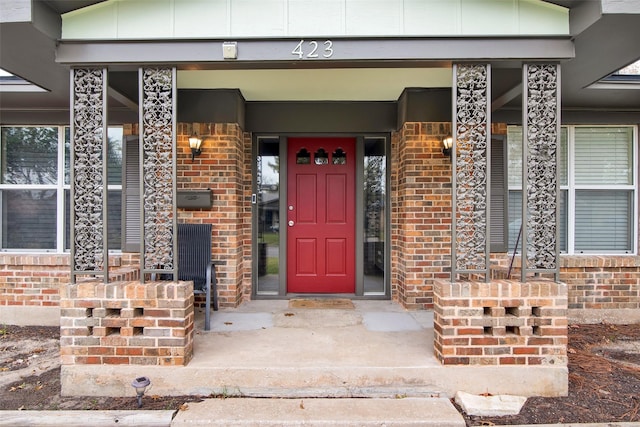 view of exterior entry with covered porch