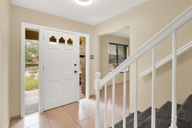 foyer entrance featuring light tile patterned floors