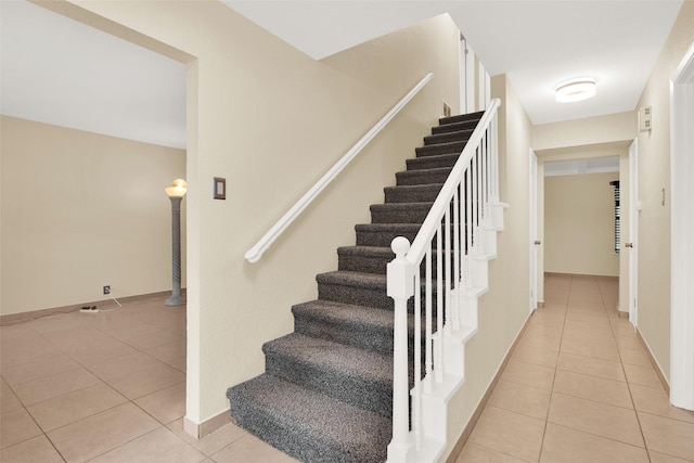 stairway with tile patterned flooring