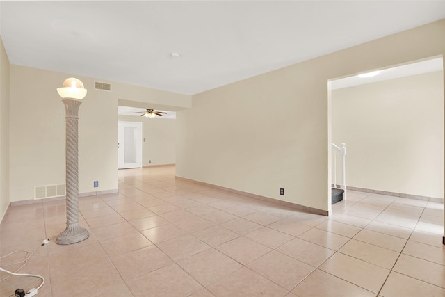 tiled empty room featuring ceiling fan