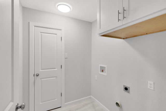 clothes washing area featuring cabinets, washer hookup, and hookup for an electric dryer