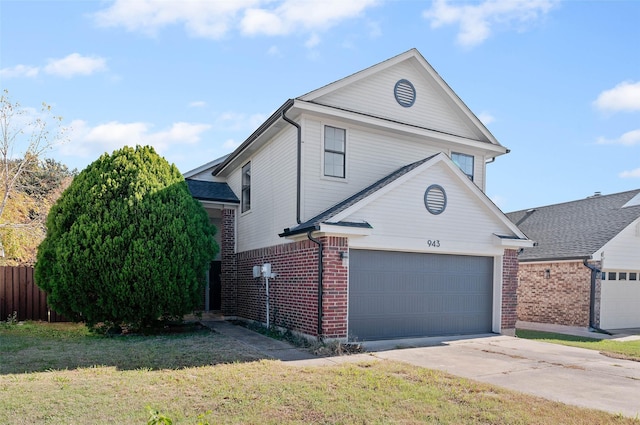 view of property featuring a garage and a front lawn