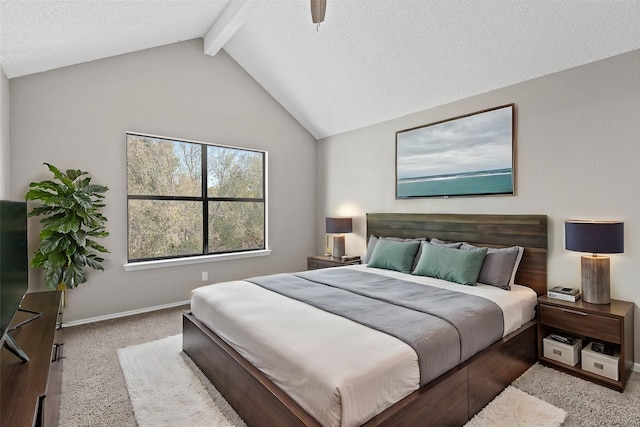 carpeted bedroom featuring a textured ceiling, vaulted ceiling with beams, and ceiling fan