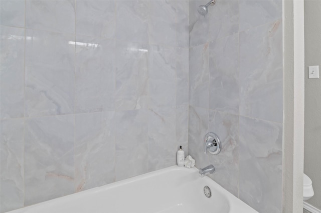 bathroom featuring tiled shower / bath