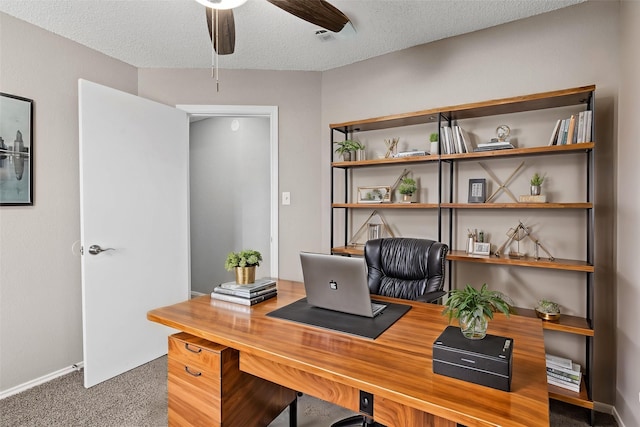 carpeted office with ceiling fan and a textured ceiling