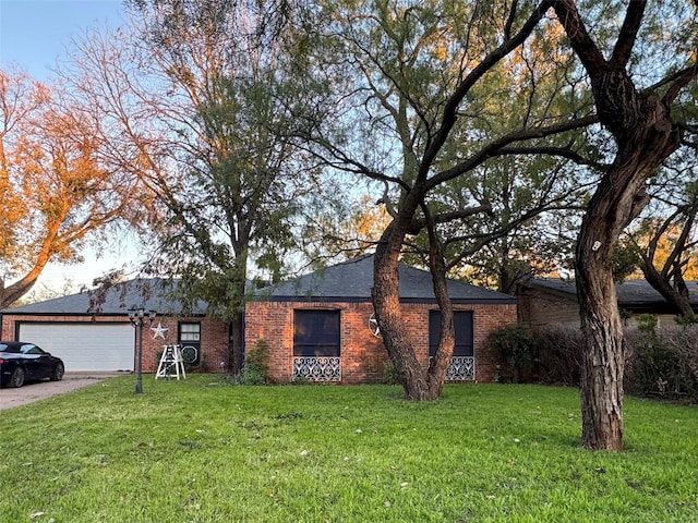 single story home with a front yard and a garage