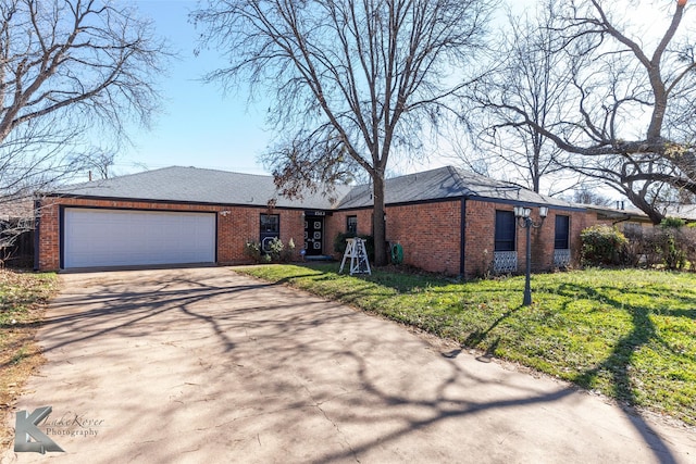 ranch-style house featuring a garage and a front yard