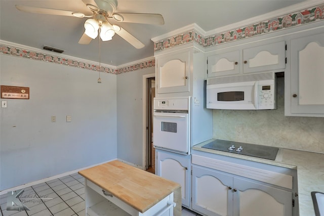 kitchen with light tile patterned floors, white appliances, ceiling fan, white cabinetry, and decorative backsplash