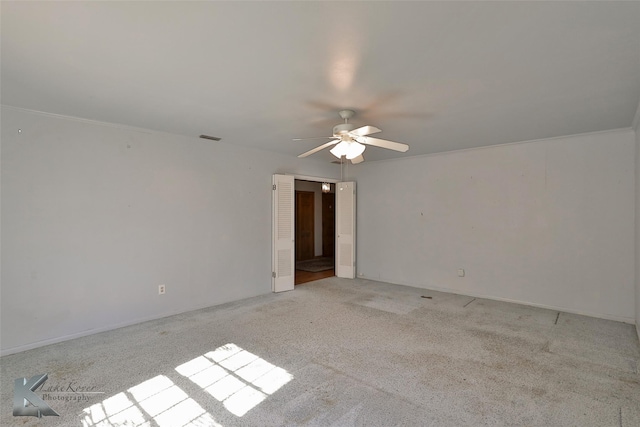 unfurnished room featuring light carpet and ceiling fan