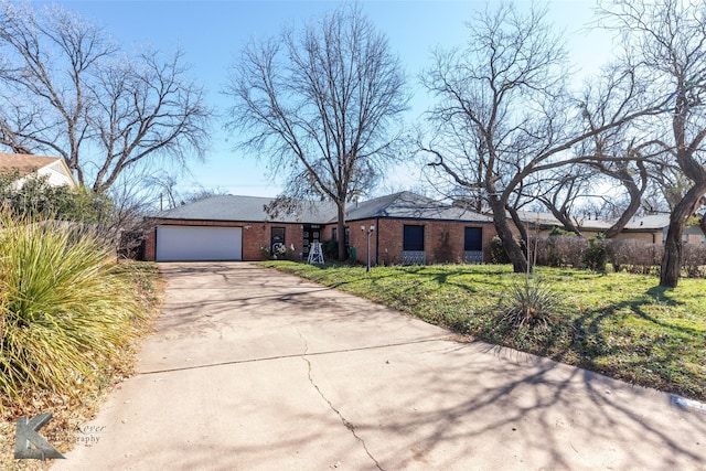 single story home featuring a garage and a front lawn