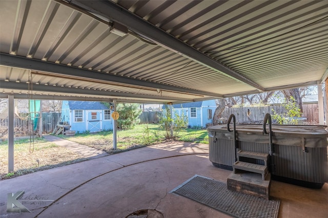 view of patio with a storage shed and a hot tub