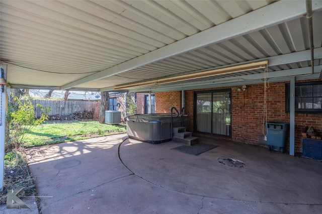 view of patio / terrace with a hot tub and central air condition unit