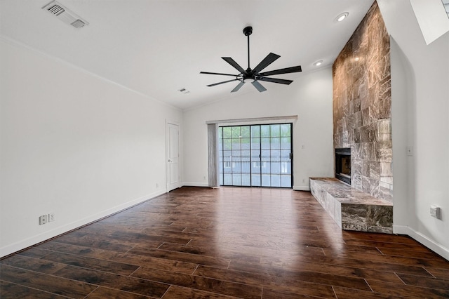 unfurnished living room featuring ceiling fan, lofted ceiling, dark hardwood / wood-style floors, and a tile fireplace