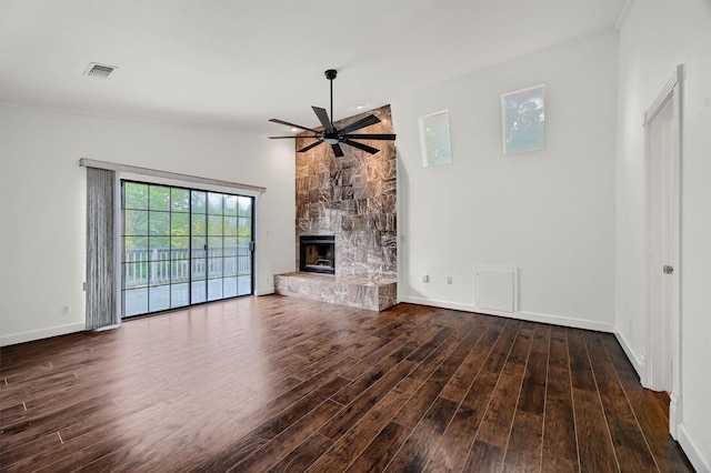 unfurnished living room featuring a fireplace, dark hardwood / wood-style floors, and ceiling fan