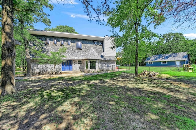 rear view of property with a yard