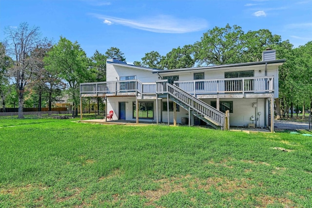 back of property with a yard, a patio area, and a deck