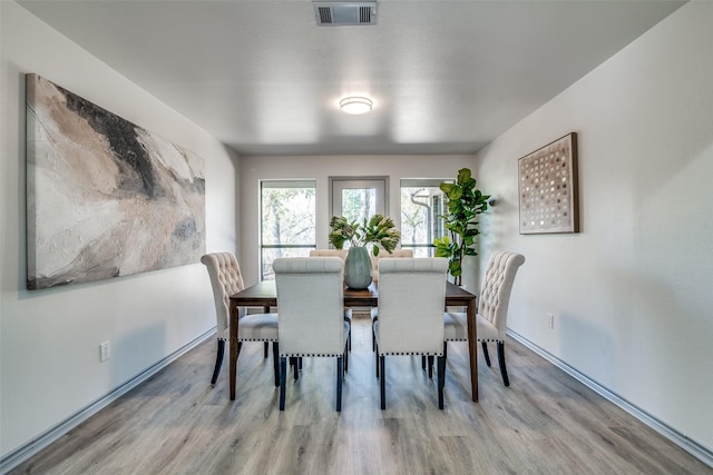 dining space with light wood-type flooring