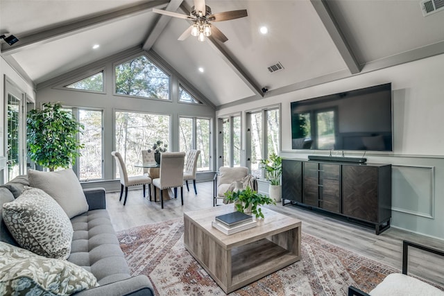 living room featuring beamed ceiling, ceiling fan, high vaulted ceiling, and light hardwood / wood-style flooring