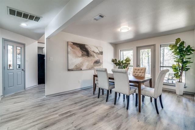 dining space featuring light hardwood / wood-style floors