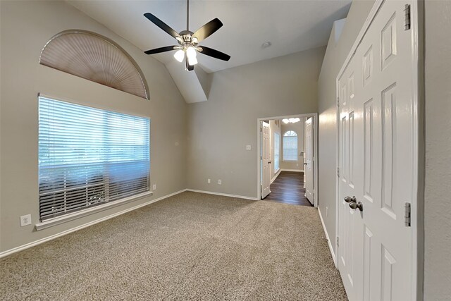 carpeted spare room with high vaulted ceiling and ceiling fan