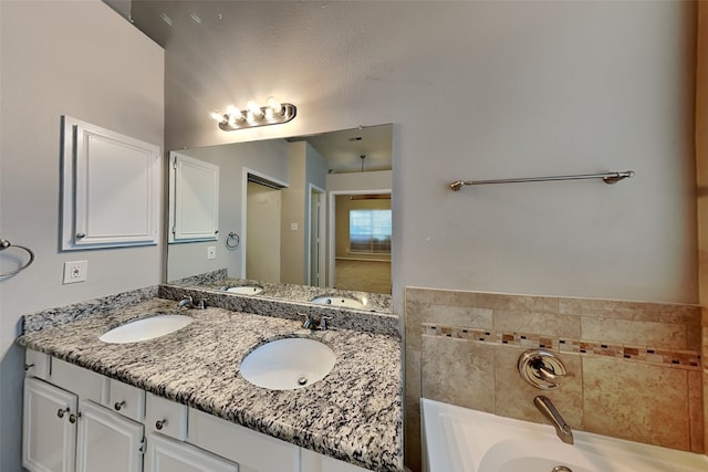 10008 Burgundy Dr, Frisco, TX 75035 - full bathroom featuring double vanity and a garden tub