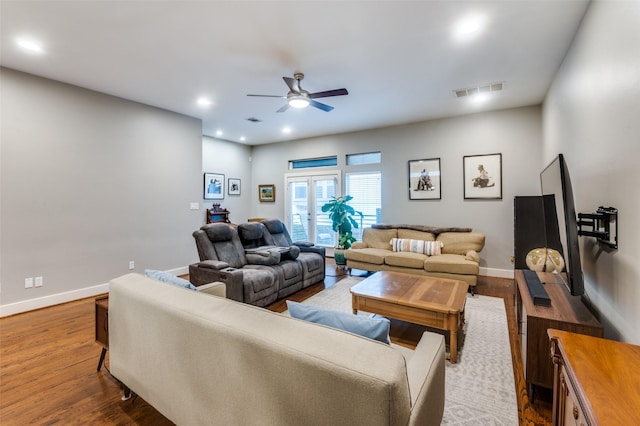 living room with wood-type flooring and ceiling fan