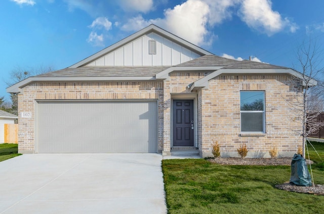 view of front of house with a garage and a front yard