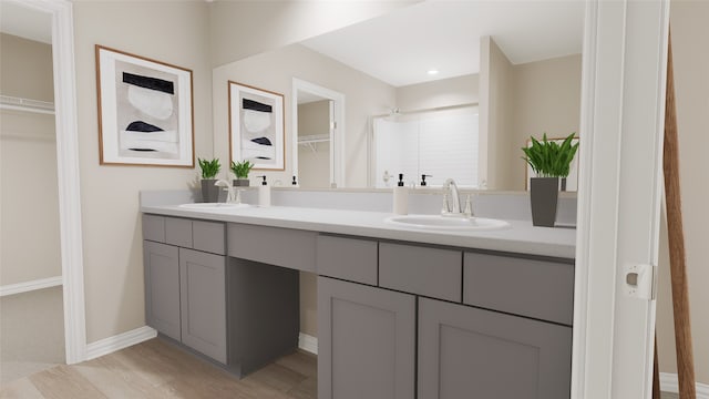 bathroom featuring vanity, wood-type flooring, and walk in shower