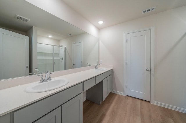 bathroom featuring vanity, hardwood / wood-style flooring, and walk in shower