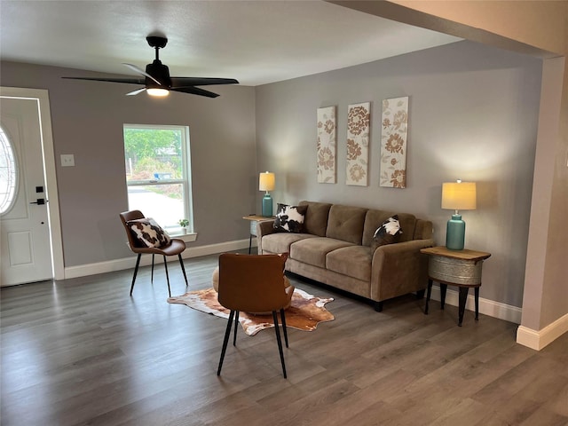 living room featuring dark hardwood / wood-style floors and ceiling fan