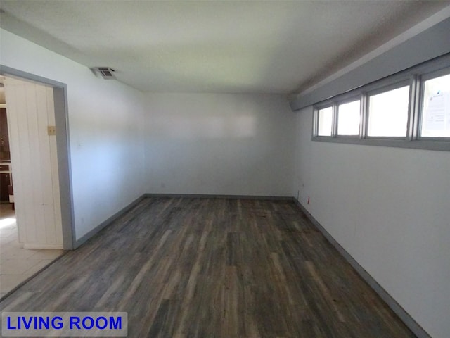 unfurnished room featuring dark wood-type flooring