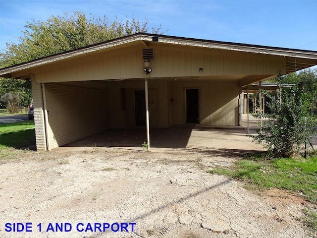 rear view of property with a carport