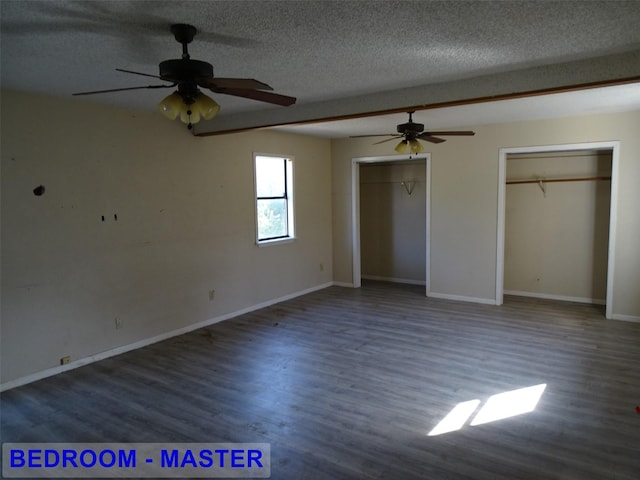 unfurnished bedroom featuring a textured ceiling, ceiling fan, and dark wood-type flooring