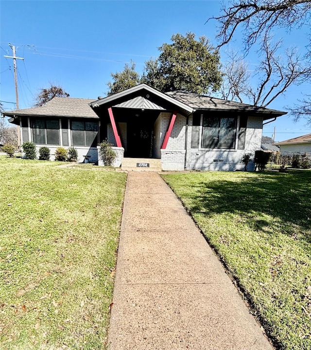 view of front of home featuring a front lawn and a sunroom