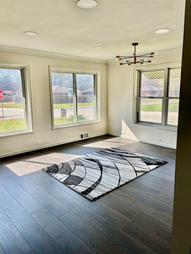 unfurnished room with an inviting chandelier and dark hardwood / wood-style floors