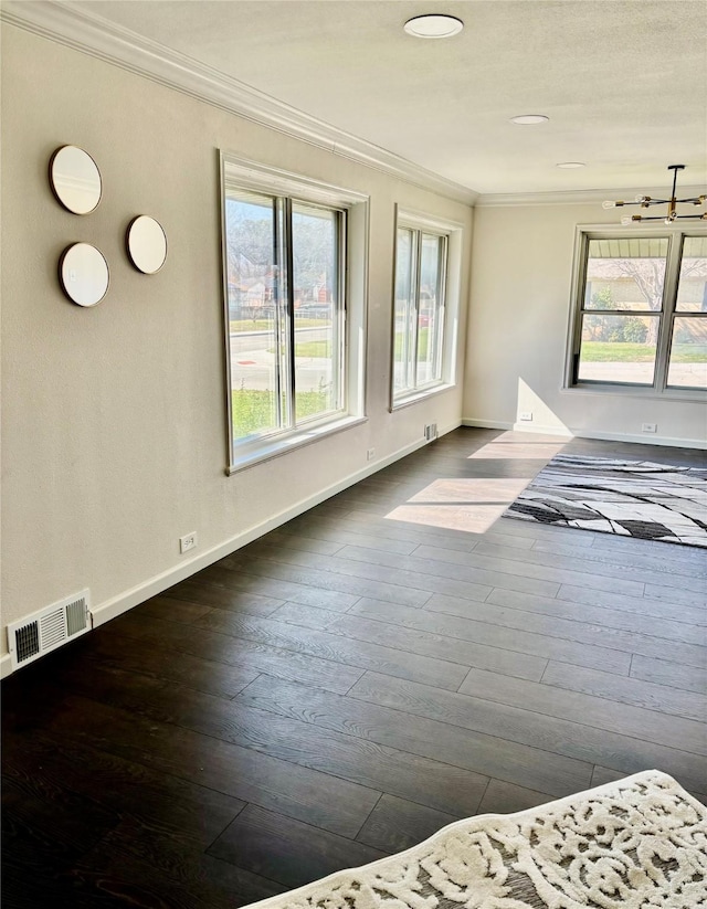 unfurnished living room featuring ornamental molding and dark hardwood / wood-style floors