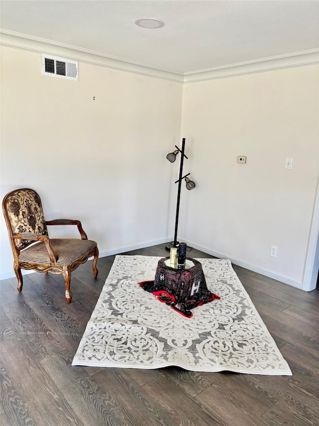 sitting room with crown molding and dark hardwood / wood-style flooring