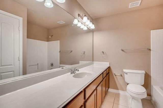 bathroom with toilet, vanity, and tile patterned floors