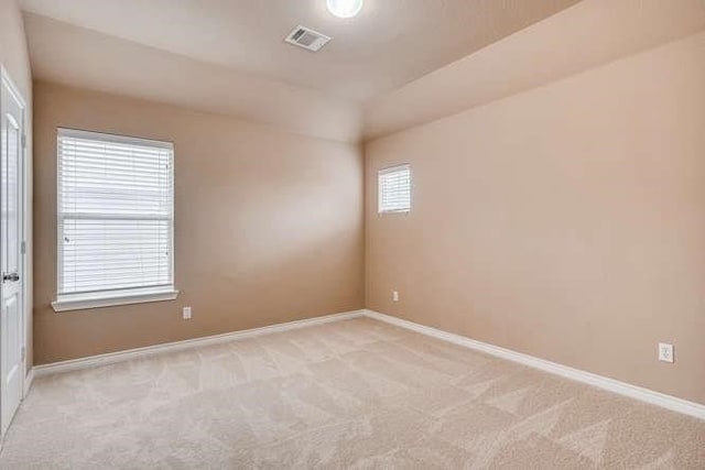 empty room featuring light carpet