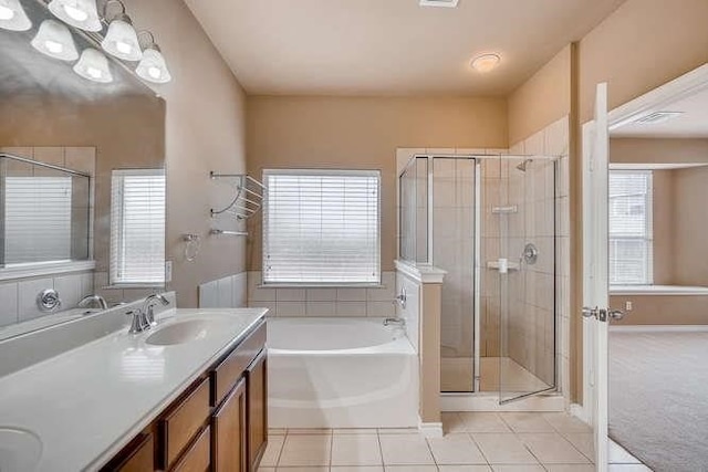 bathroom with tile patterned flooring, vanity, and independent shower and bath