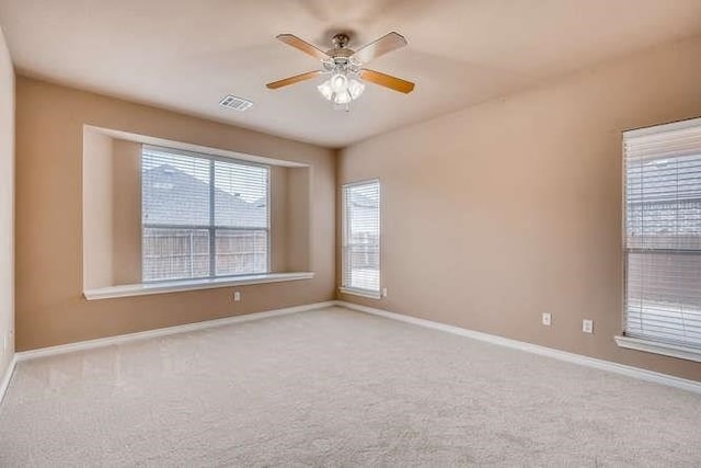 unfurnished room with ceiling fan and light carpet