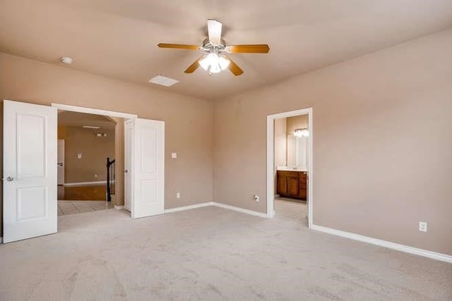 unfurnished bedroom with light carpet, ceiling fan, and ensuite bathroom