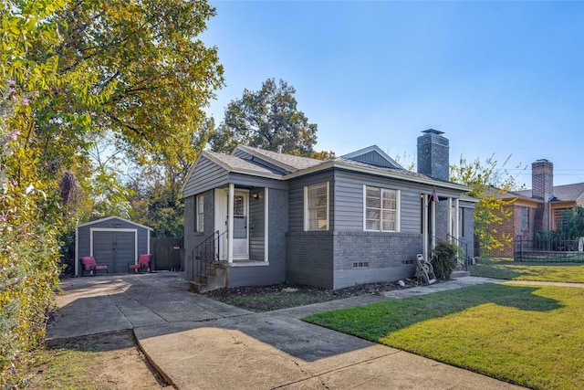 bungalow-style home featuring a storage unit and a front yard