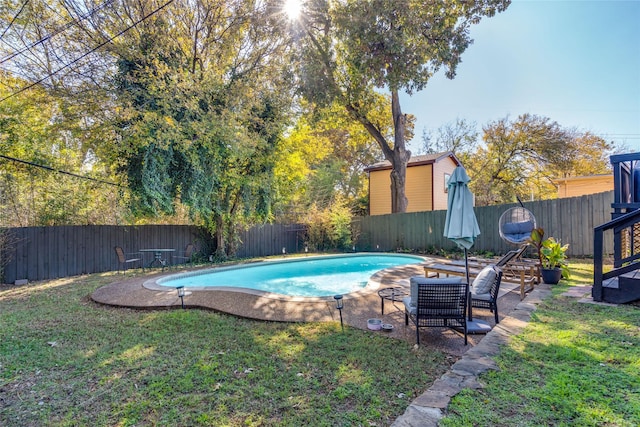 view of swimming pool featuring a yard, a patio, a fenced backyard, and a fenced in pool