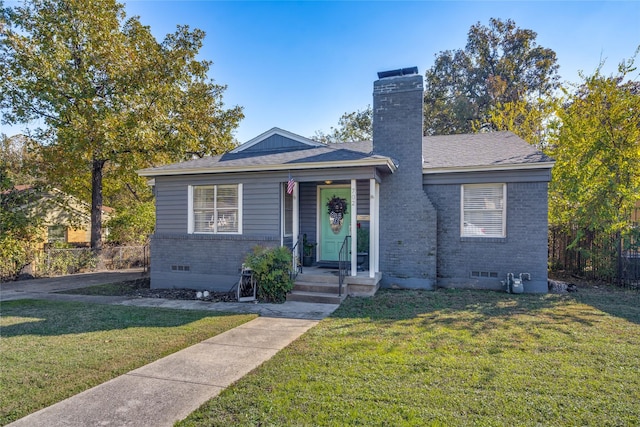 bungalow with a front yard, crawl space, brick siding, and a chimney